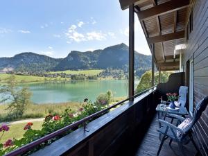 a balcony with a view of a lake and mountains at Rosenhof am See Ferienwohnung Alpenrose in Thiersee