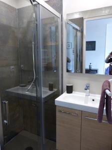 a bathroom with a glass shower and a sink at Appartement Topaze Bourg d'Oisans in Le Bourg-dʼOisans