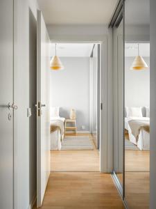 an open door leading to a bedroom with a bed at 2ndhomes Tampere "Tower" Apartment - Brand New Modern Apartment with Balcony and Central Location in Tampere