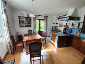 a kitchen with a wooden table and a dining room at Haus Irblingweg in Stiefern