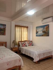 Postel nebo postele na pokoji v ubytování Hostal Familiar Rolo
