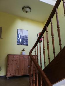 a staircase in a house with a wooden cabinet at Gastehaus Heigeleshof in Ulm