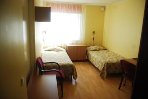 Postel nebo postele na pokoji v ubytování Mardi Hotel