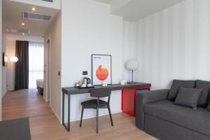 a living room with a table and a couch at Hotel Punta Tipa in Trapani