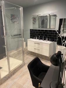 a bathroom with a glass shower and a sink at O'GB La Rennaissance in Chenonceaux