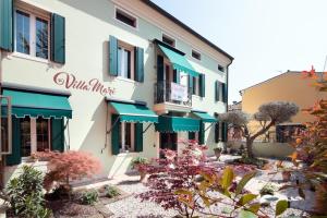 a building with blue and green awnings at Villa Mari in Montagnana +18 photos