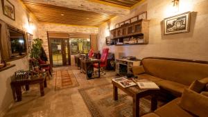 a living room with a couch and a desk at In Stone House in Goreme