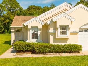 a house with bushes in front of it at Sunshine, Love, And Happiness In A Home Thats Cute As A Button - 3bd 2552 in Kissimmee