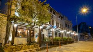 a building with lights on a street at night at In Stone House in Goreme