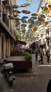 a group of umbrellas hanging over a street at Antica Casa Centro in Catania