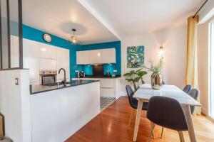 a kitchen and dining room with a table and chairs at L'étoile annécienne - 3 rooms 80 square meter - Terrace in Annecy