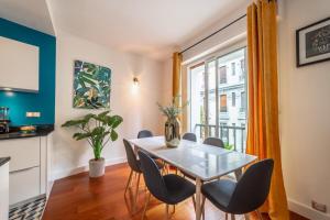 a dining room with a table and chairs and a window at L'étoile annécienne - 3 rooms 80 square meter - Terrace in Annecy +14 photos
