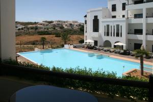 a view from the balcony of a hotel with a swimming pool at Belmar Spa & Beach Resort in Lagos