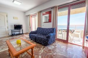a living room with a couch and a view of the ocean at Apartamentos Nuevo México C 142 in Calpe