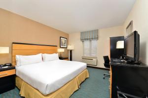 a hotel room with two beds and a television at Holiday Inn Express Kennedy Airport, an IHG Hotel in Queens