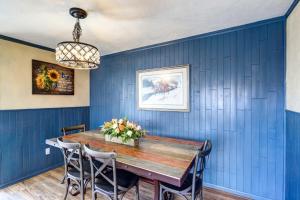 a dining room with blue walls and a wooden table at Charming Montrose Family Home Block to Downtown! in Montrose