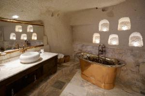 a large bathroom with a tub and a sink at Artemis Cave Suites & Spa- Adults Only in Goreme