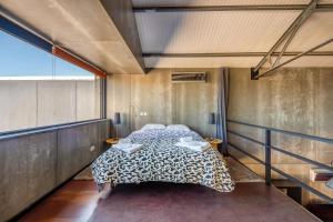 a bedroom with a bed in a room at The Loft - a birdwatchers paradise in Fuzeta