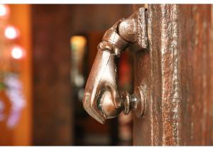 an old rusty faucet on a wooden door at La Casona de Calderón Gastronomic & Boutique Hotel in Osuna