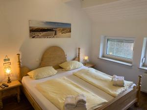 a bedroom with a bed with two shoes on it at Ferienhaus Schonerweg 9 in Norddeich in Norddeich