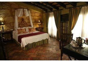 Posteľ alebo postele v izbe v ubytovaní La Casona de Calderón Gastronomic & Boutique Hotel