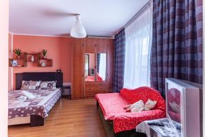 莫斯科的住宿－梅尼科瓦越橘無產階級公寓，一间带两张床、一张沙发和一台电视的卧室