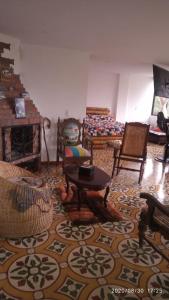 een woonkamer met meubels op een tapijt bij Hospedaje Rural El Rancho de Amelia y Juancho in Silvania