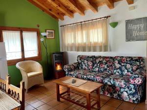 a living room with a couch and a table at El Hayuco de Montejo in Montejo de la Sierra
