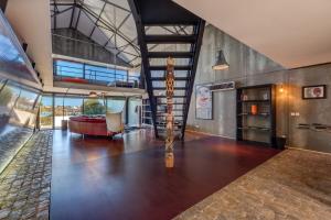 a large living room with a couch and a table at The Loft - a birdwatchers paradise in Fuzeta