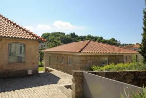 a brick house with a tile roof at Casa da Padaria in Mondim de Basto