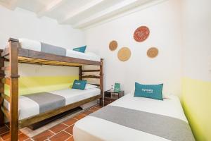 Katil atau katil-katil dalam bilik di Casa de Pinos Hotel