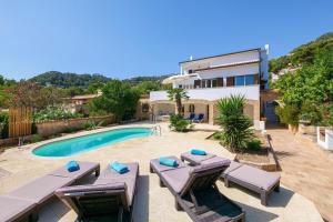 a villa with a swimming pool and a house at Villa Albatros in Canyamel