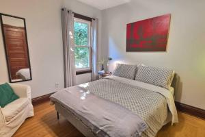 a bedroom with a bed and a window at Dundurn Dwelling-Charming Century Home in Hamilton