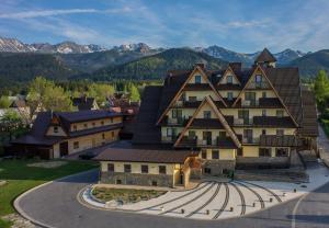 an aerial view of a building with mountains in the background at Helan Family & SPA in Zakopane