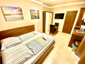 A bed or beds in a room at Unio Vendégház 1