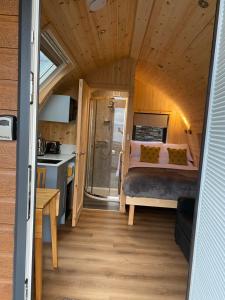a bedroom with a bed in a tiny house at Mallaig Glamping Pods in Mallaig