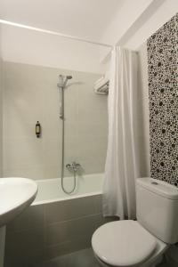 La salle de bains est pourvue de toilettes, d'une douche et d'un lavabo. dans l'établissement Pan Hotel, à Athènes
