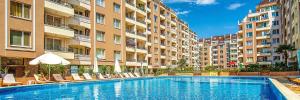 a swimming pool in front of a large building at Perla Luxury Apartment in Burgas