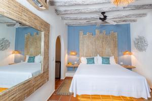 Postel nebo postele na pokoji v ubytování Holbox Dream Beachfront Hotel