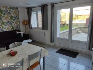 a living room with a table and a couch at Le Crotoy Plage Baie de somme Appt l'Aigrette in Le Crotoy