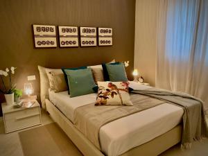 a bedroom with a large bed with green pillows at Villa Luminosa in Torre del Lago Puccini