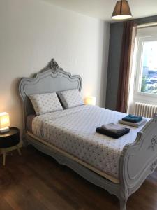 a bedroom with a white bed with two towels on it at Appartement Guéret in Guéret