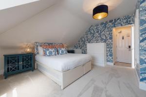a bedroom with blue and white wallpaper and a bed at Somerset House Boutique Hotel and Restaurant in Portsmouth