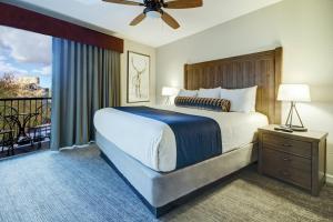 a bedroom with a large bed and a balcony at Club Wyndham Durango in Durango