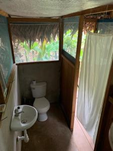 a small bathroom with a toilet and a sink at Katari Center in Tarapoto