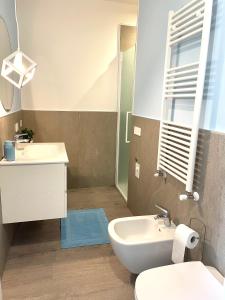 a bathroom with a sink and a toilet and a mirror at Appartamento Azzurro in Verona