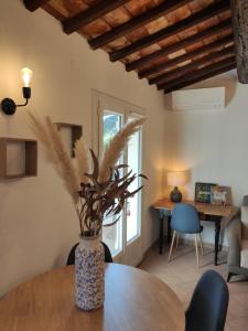 a vase on a table in a living room at La Ramade de Saint-Tropez in Saint-Tropez
