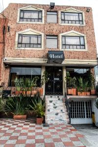 a brick building with a hotel sign on it at Hotel Fénix Real Bogotá in Bogotá +16 photos