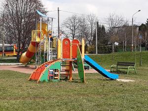 a playground in a park with a slide at Na Złotych Łanach - apartament z parkingiem in Bielsko-Biała