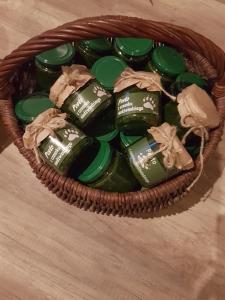 a basket filled with green glass bottles on a table at Przystań u Bieszczadnika in Lutowiska